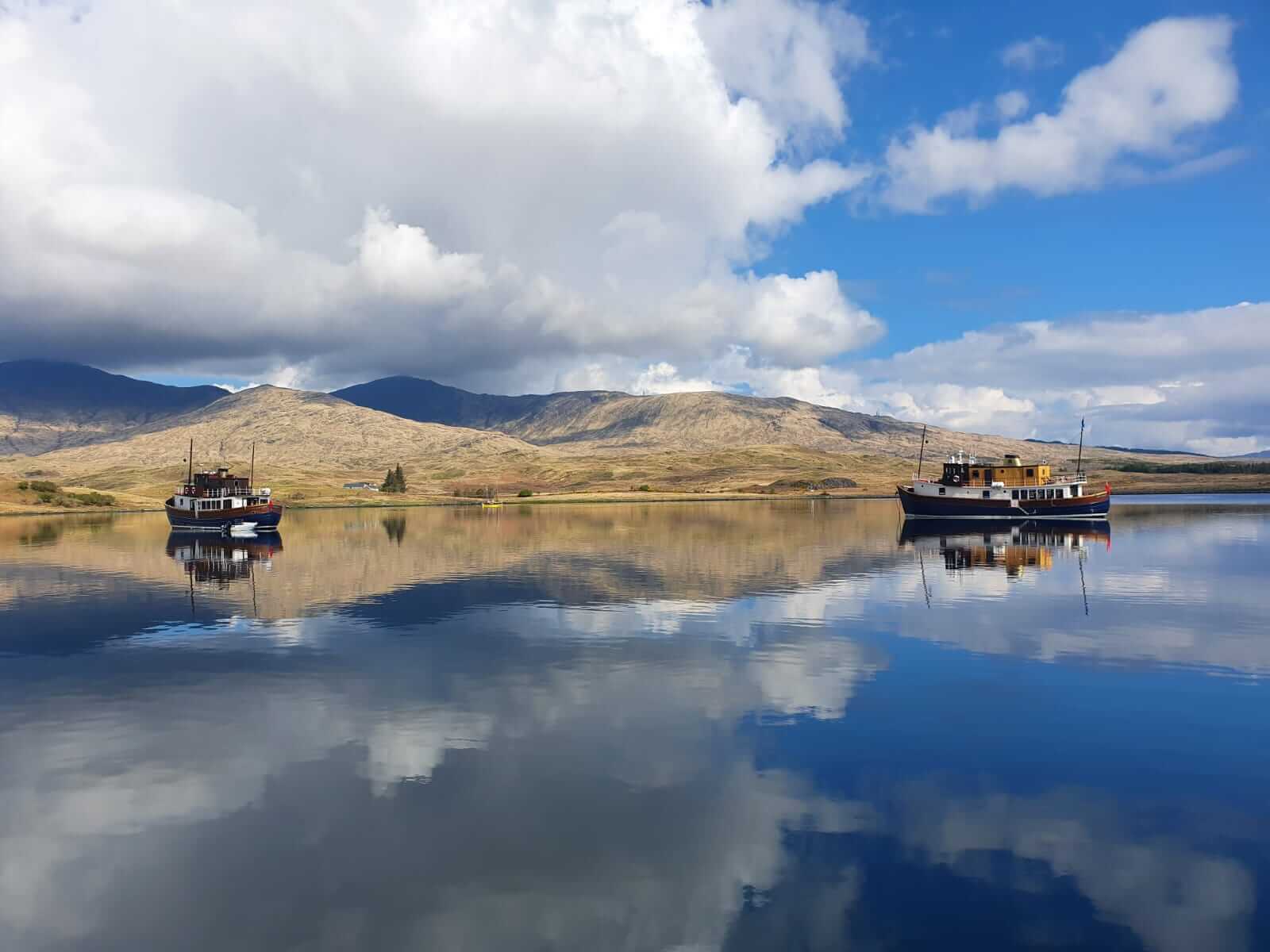 2 boats out on the water on a clear day