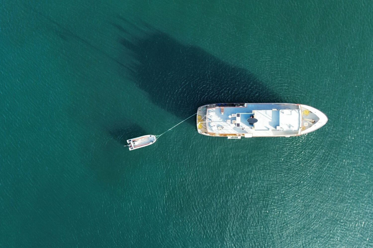 top down view of cruise ship on crystal clear water