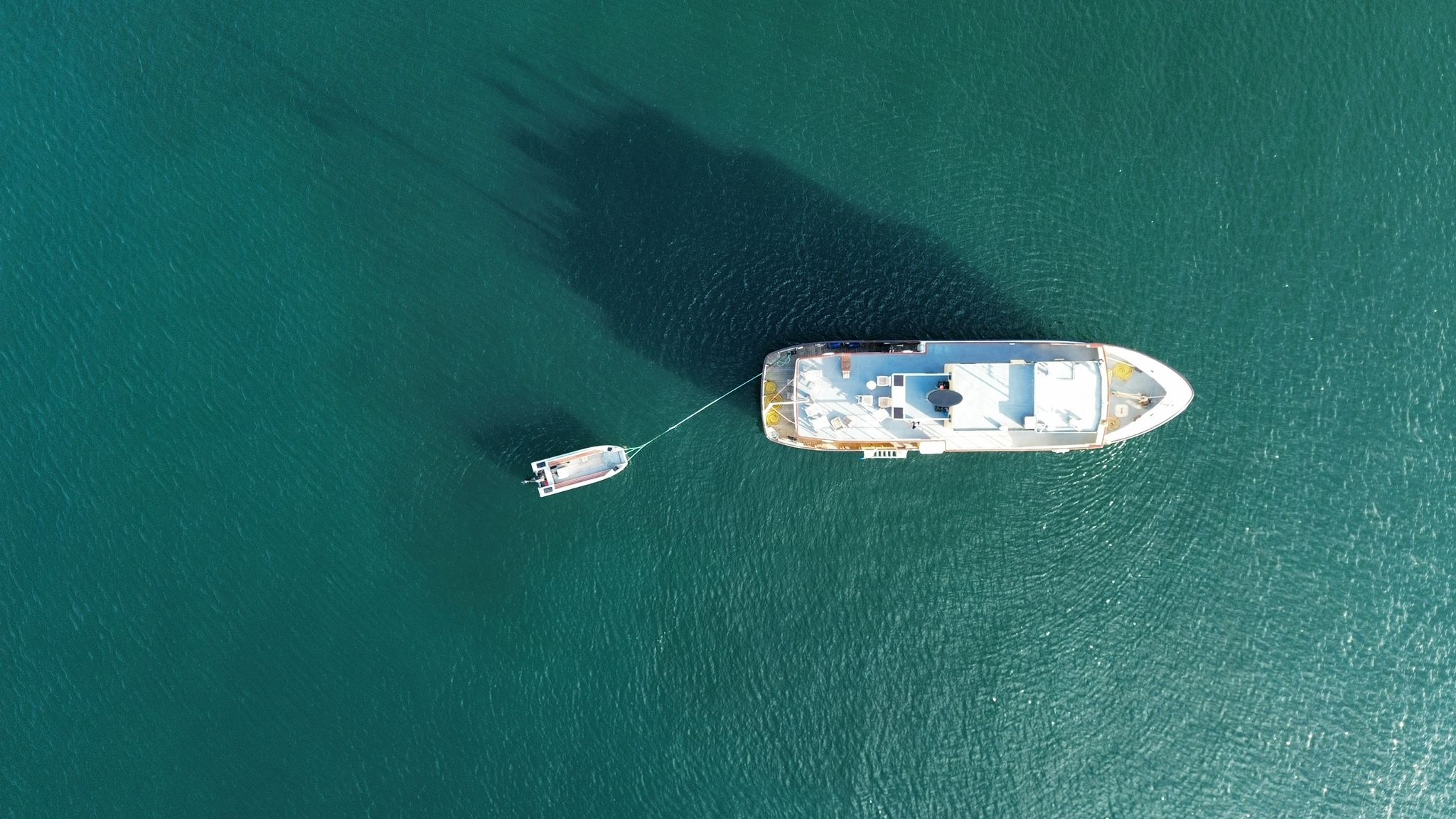 top down view of cruise ship on crystal clear water