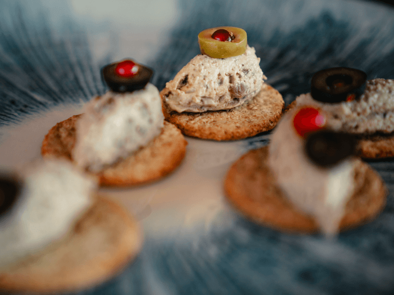 A selection of crackers with a range of toppings on them