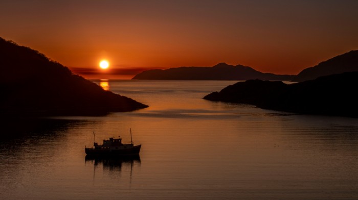 One of our vessels out at sea at sunset