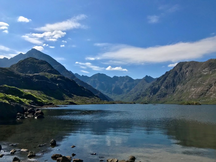 Lake on a sunny day with mountains in the distance