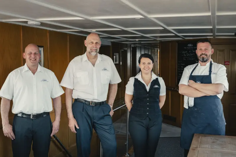 Staff smiling the camera on board our ship