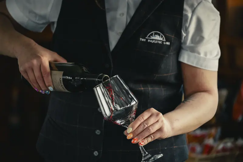Staff member pouring wine into glass